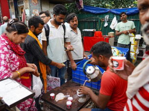 Vishnu Singh, 38, serves tea to patients, caregivers and others outside the hospital. Singh runs the stall with his brother, Arjun, and keeps it open 24 hours a day.