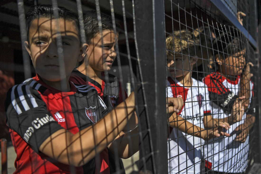 Children wait to play football in the minor leagues of Newell's Old Boys, where Argentine football star Lionel Messi used to play in Rosario, Argentina, 2018.