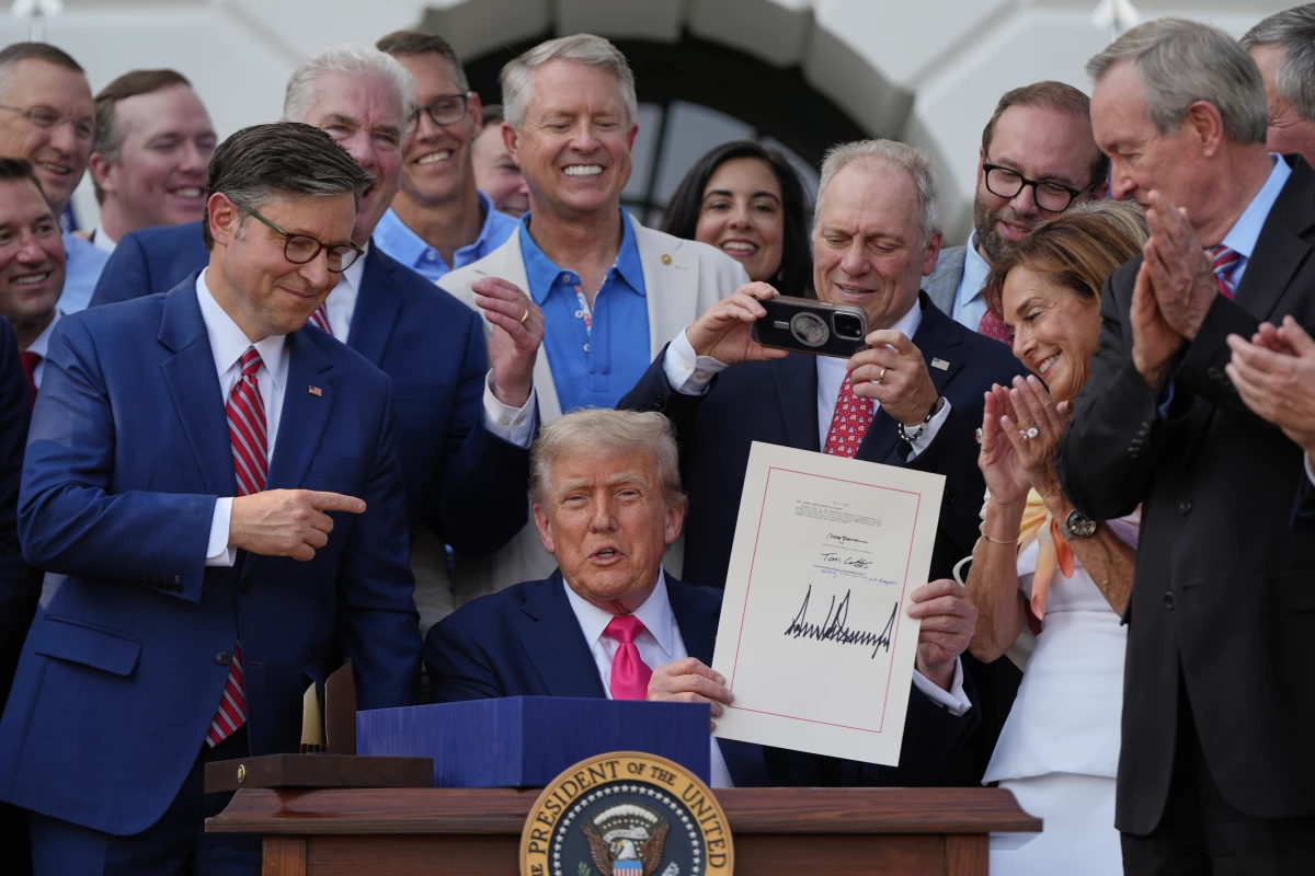 President Donald Trump and Republican members of Congress at the signing ceremony for his tax cut and spending bill on July 4, 2025. That law makes it a requirement for many adults who get Medicaid to prove that they are working.