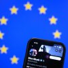 This illustration photograph shows Elon Musk's X (formerly Twitter) account displayed on a smartphone in front a European Union flag.