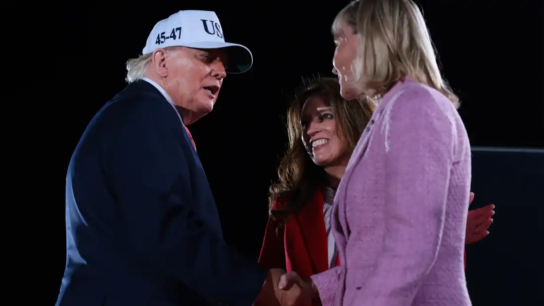 North Carolina Republican Congressional candidates, State Rep. Jennifer Balkcom and Laurie Buckhout (R) are embraced by President Trump during an election rally on October 20, 2026 in Greenville, North Carolina. Buckhout is running in North Carolina's 1st District which was redrawn to heavily favor Republicans and is now a toss-up.