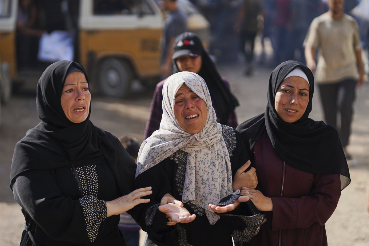 Relatives of Palestinians killed in Israeli strikes on the Gaza Strip mourn their deaths at Al-Shifa Hospital in Gaza City, Saturday, June 28, 2025.
