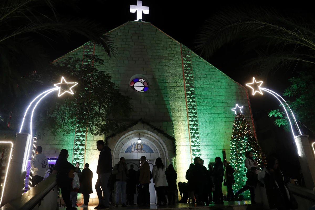 Palestinian Christians wait to pray at the midnight Christmas Eve Mass out side the Deir Al Latin Holy Family Catholic Church in Gaza City, 2021.