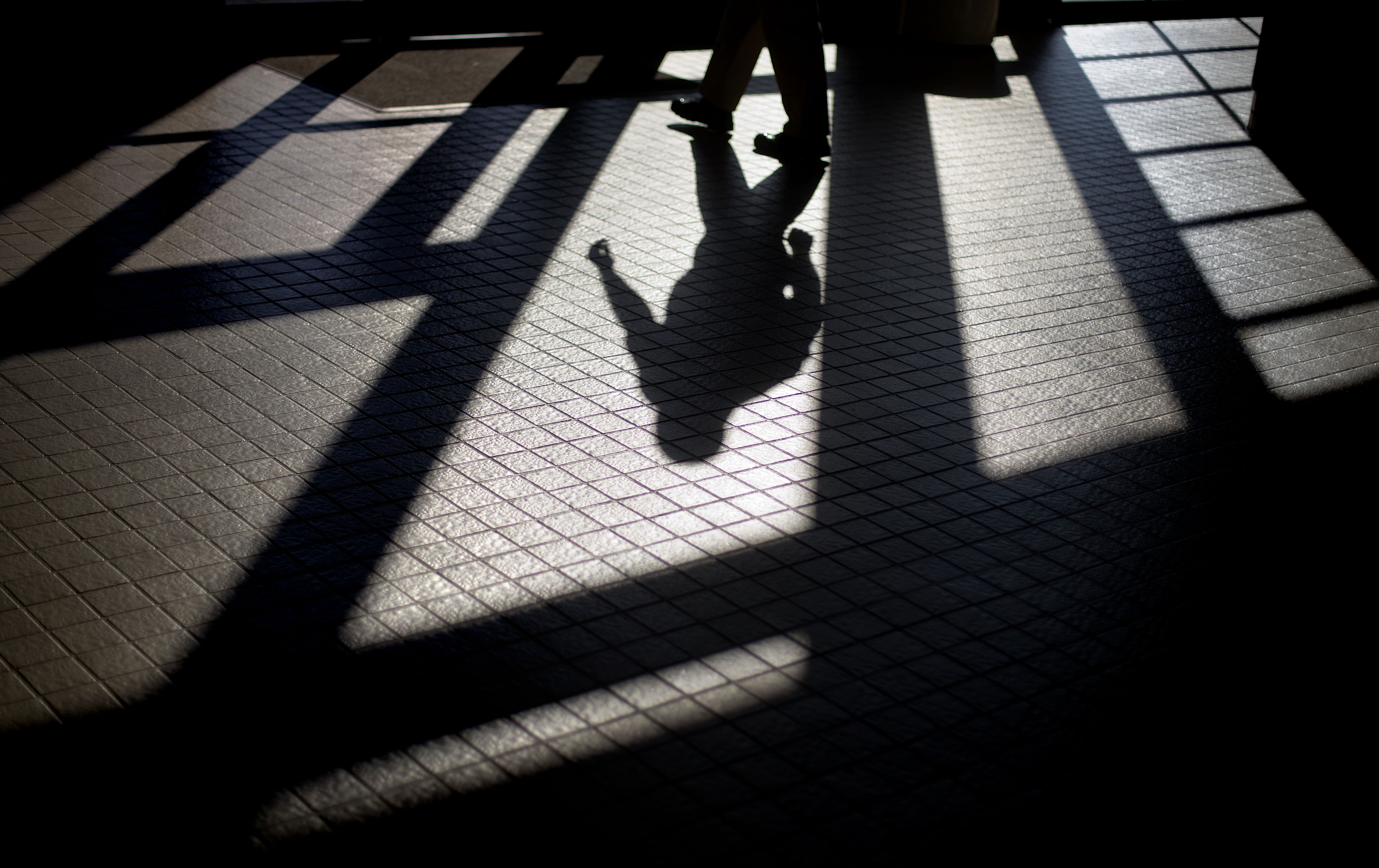 In this 2012 photo, the shadow of a Georgia Department of Juvenile Justice correctional officer is cast as he leaves a training facility.