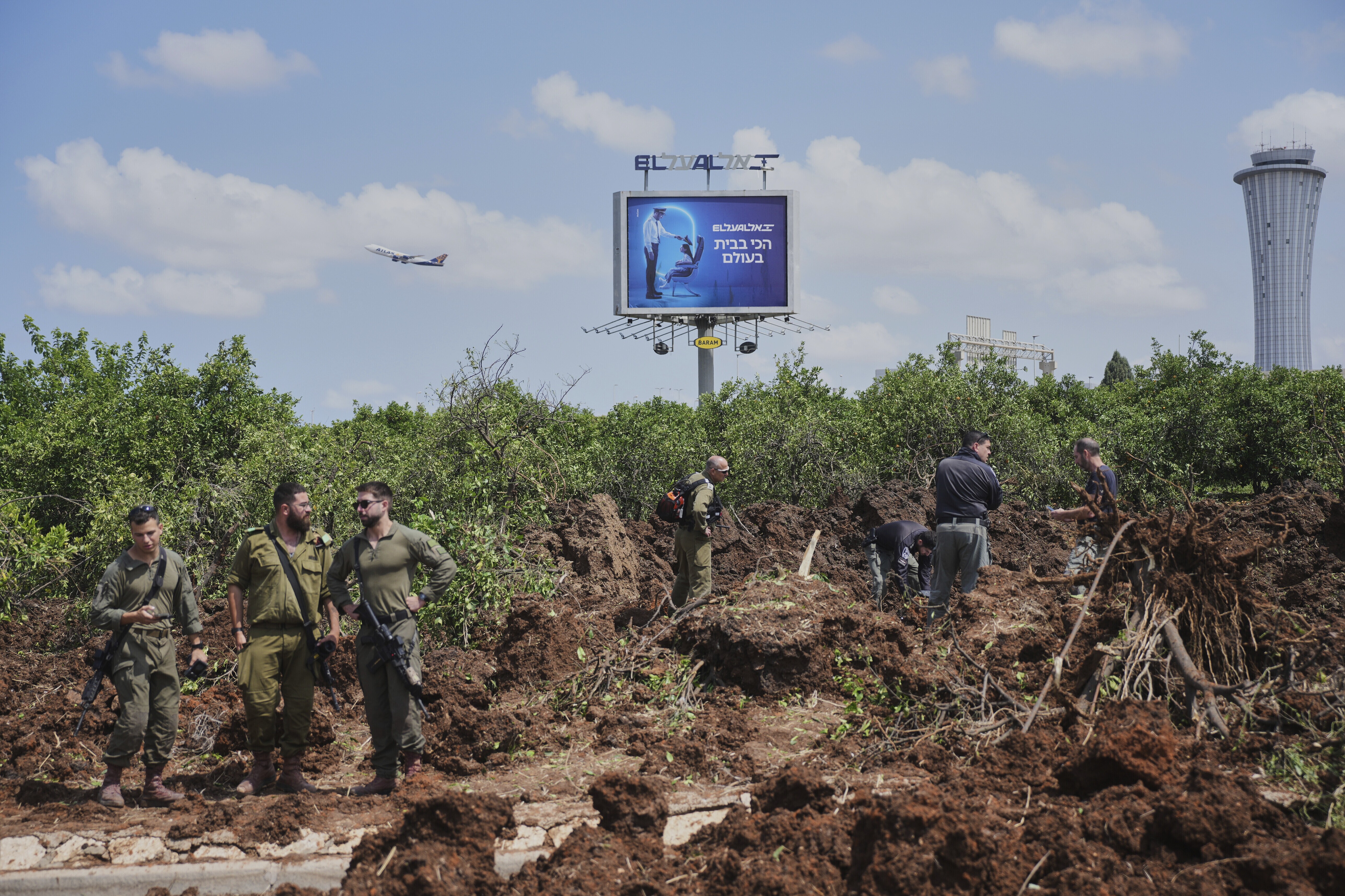 Israeli security forces inspect the site where the Israeli military said a projectile fired by Yemen