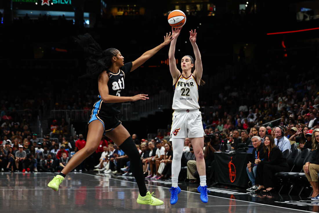 Caitlin Clark #22 of the Indiana Fever shoots against Angel Reese #5 of the Atlanta Dream during the first quarter at State Farm Arena on June 20 in Atlanta.