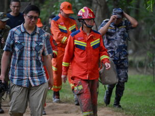 China Fire and Rescue personnel arrive at Trishuli camp after inspecting the tunnel site in Rasuwa, in the aftermath of flash floods in Nepal's Nuwakot district on August 31, 2026. Rescuers struggled on August 31 through mud and debris for a sixth day, as the number of missing people soared to nearly 5,000 since tsunami-like glacial floods roared down from the China-Nepal border, creating an