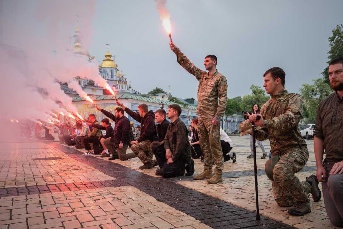 People light up flares during the funeral ceremony of fallen Ukrainian serviceman Yaroslav Ivanov in Kyiv, Ukraine, on June 8.