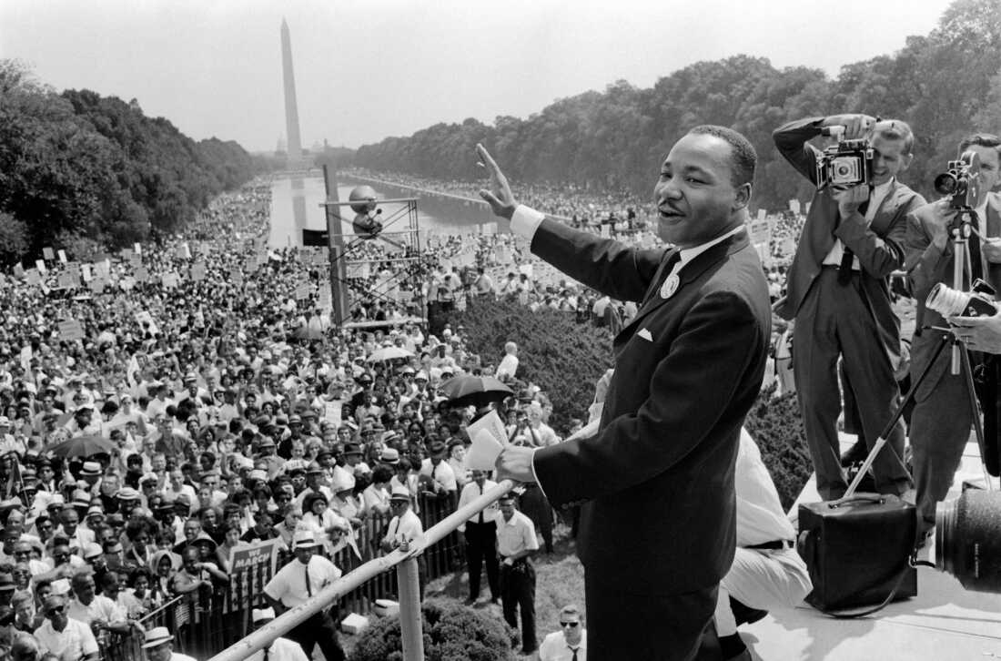 U.S. civil rights leader Martin Luther King Jr., waves to supporters on August 28, 1963, on the National Mall in Washington D.C.