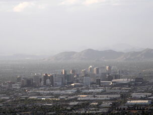 The sun sets on the Phoenix skyline on April 26, 2026. The nation's fifth-largest city will get less water from the Colorado River, but groundwater, another nearby river system and expensive technology will help it adapt to those cuts.