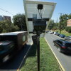 Traffic flows past an Axon brand automated license plate reader (ALPR) camera in Silver Spring, Md. on August 19, 2026. Some cities are making the switch to Axon cameras since law enforcement technology company Flock has come under intense scrutiny over a series of alleged abuses of the company’s tools. (Photo by Chip Somodevilla/Getty Images)