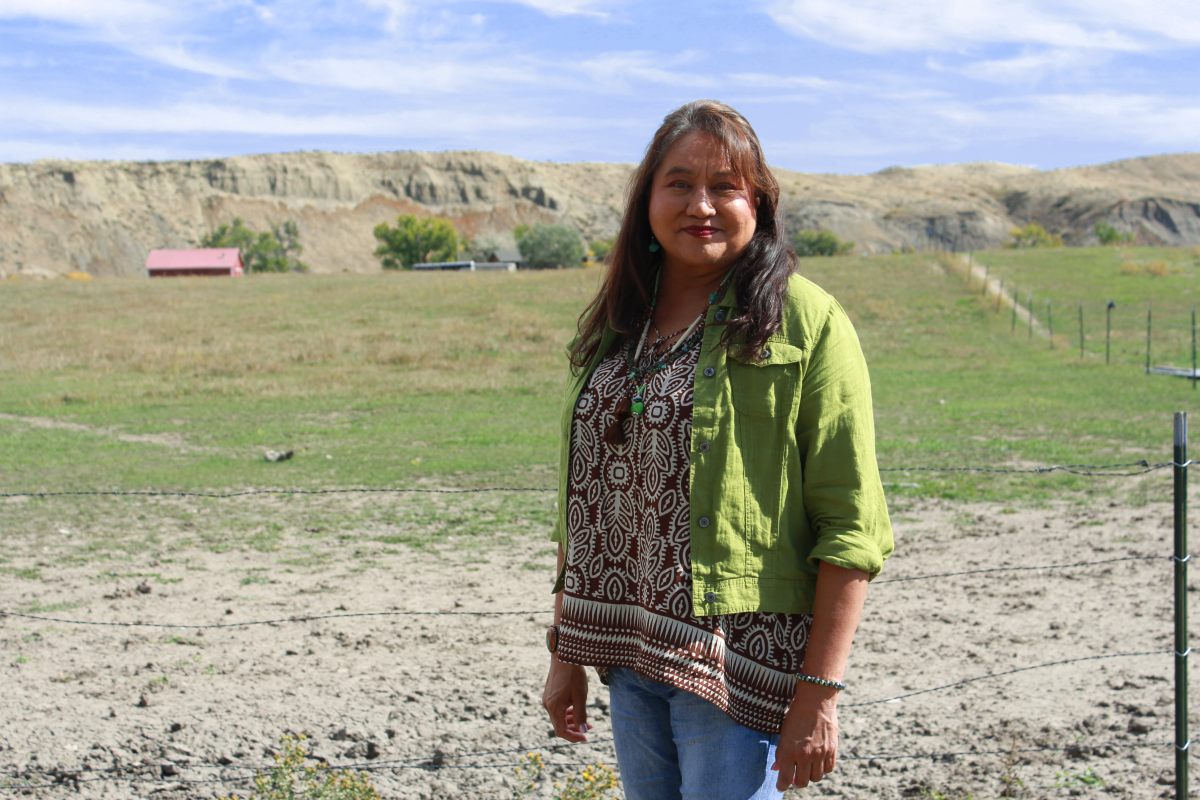 LeeAnn Bruised Head stands before the hillside near her childhood home on the Crow Indian Reservation, where she grew up riding horses.
