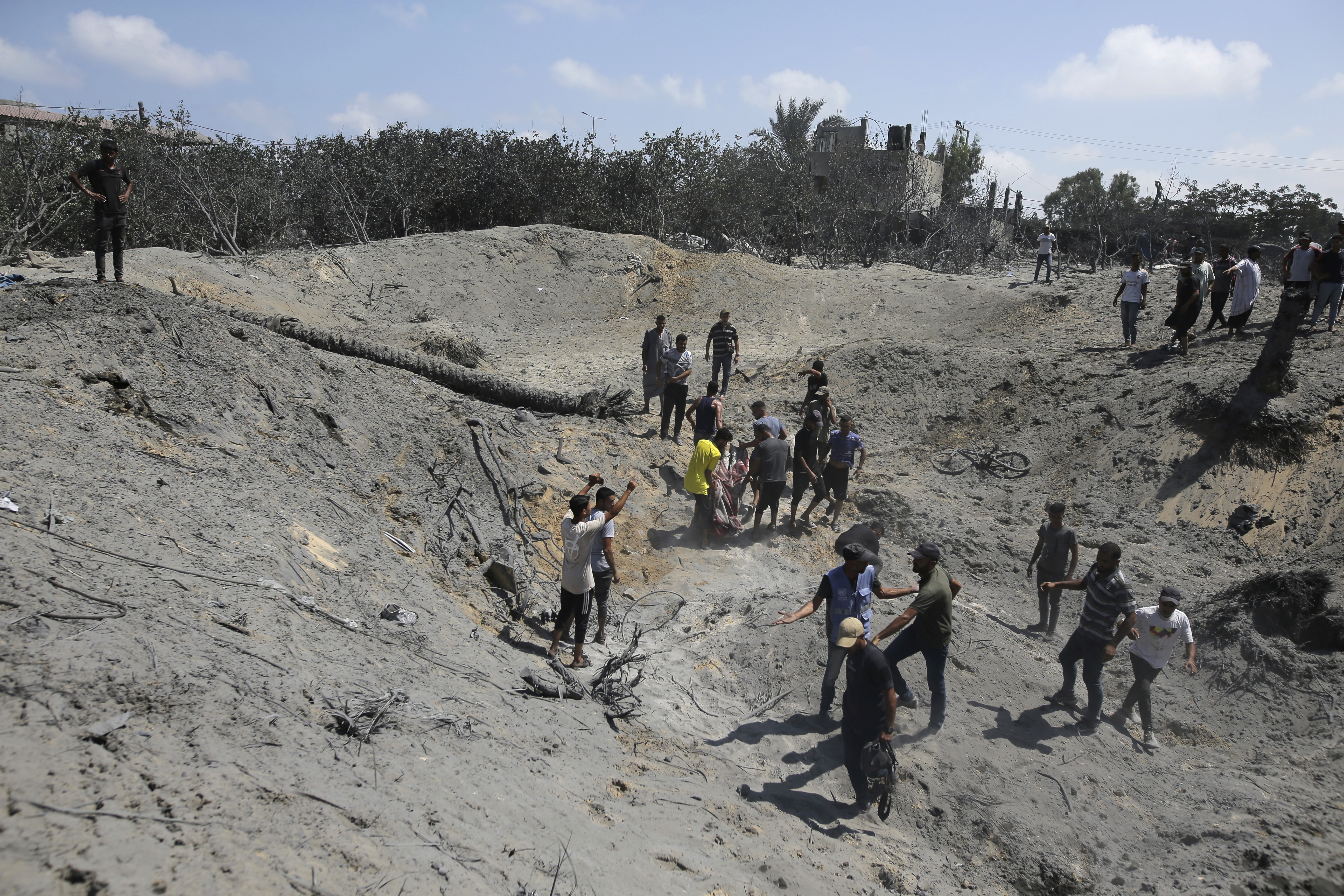 Palestinians search for bodies and survivors in a site hit by an Israeli bombardment on Khan Younis, southern Gaza Strip, on July 13 in which the Israeli military claim they killed the head of Hamas