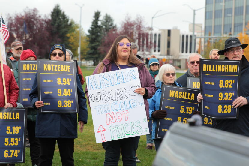 Ana Rodriguez, a member of Alaska's caregiver union, brought a homemade sign to a rally opposing President Trump's visit. It read: 'Alaskans bear the cold, not prices.' Other protesters held signs showing gas prices in various Alaska communities.