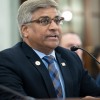 In this 2023 photo, Sethuraman Panchanathan, then the director of the National Science Foundation, testifies at a Senate committee hearing. He's wearing a suit and is seated in front of a microphone.