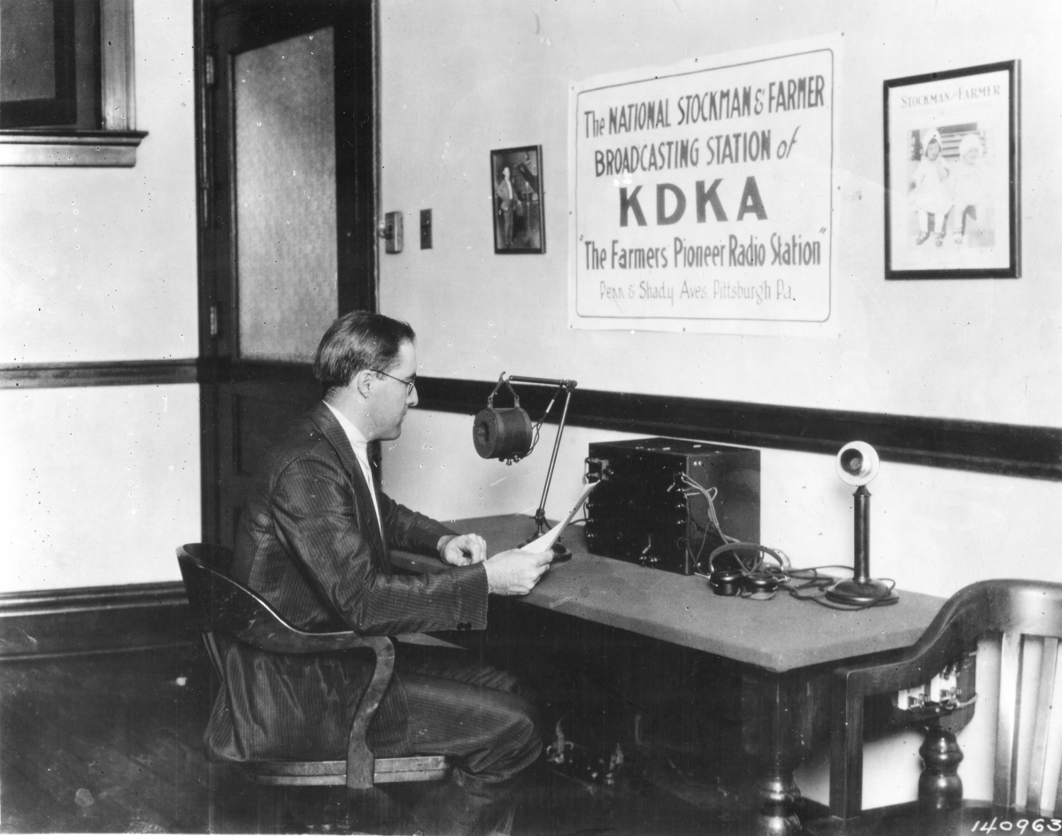 Broadcaster Frank Mullen reads radio copy into the microphone at KDKA in Pittsburgh in 1922.
