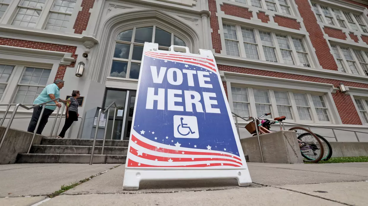 People walk into a New Orleans school to cast their votes in Louisiana's statewide primary on May 16.