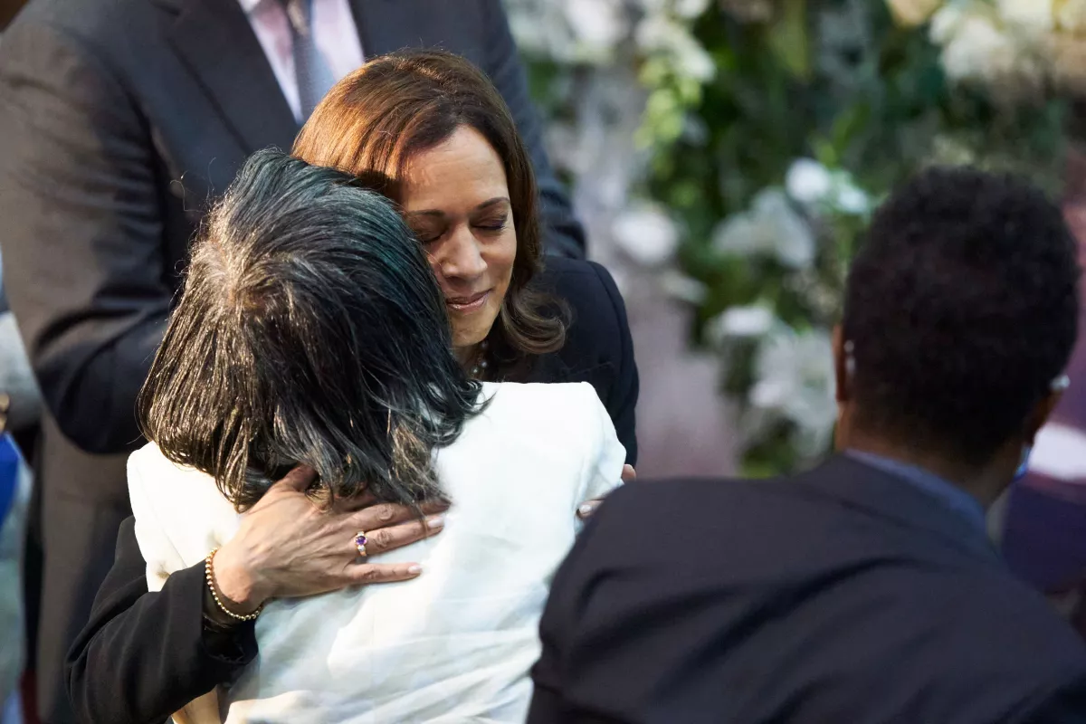 Vice President Harris hugs Robin Harris, the daughter of shooting victim Ruth Whitfield, during Whitfield's funeral service at Mt. Olive Baptist Church in Buffalo, N.Y., on May 28, 2022.