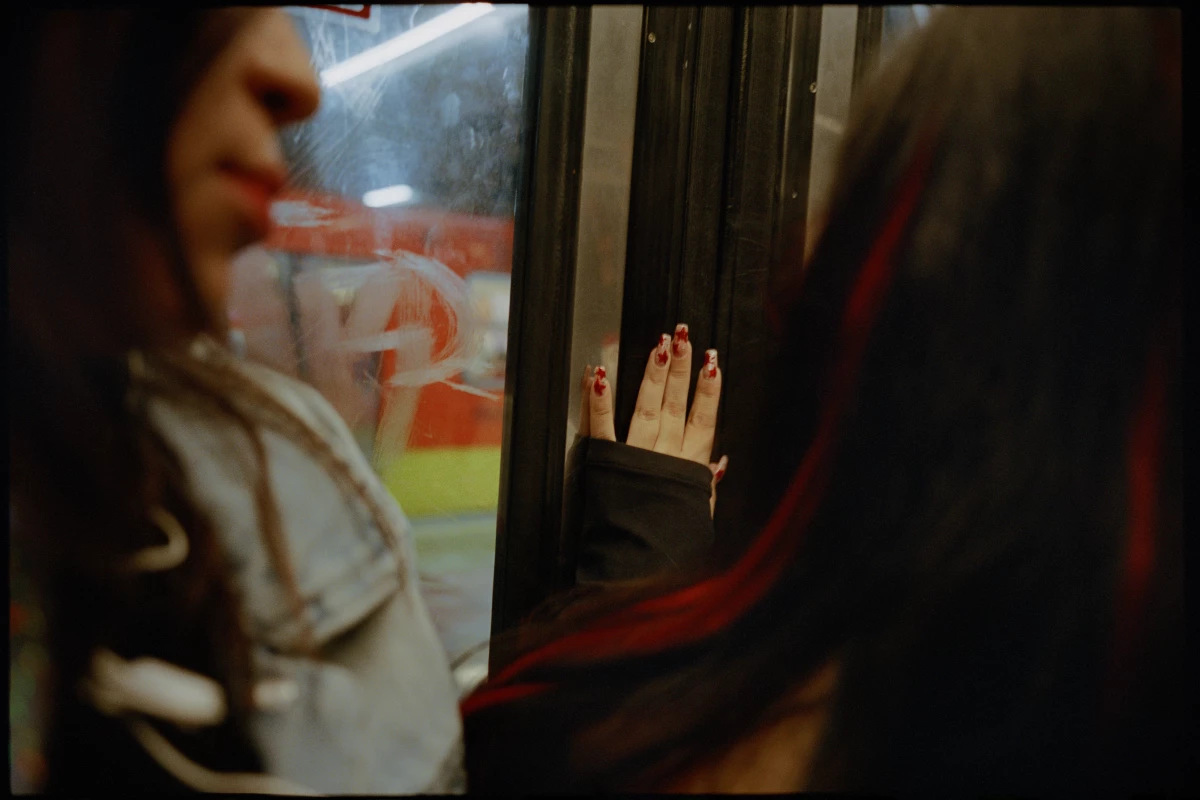 A woman places her hand on the metro car sliding door in December 2023.