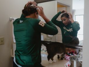 Sabrina Robinson, the Boston Hunters' first baseman, fixes her hair in her hotel room before going out with her fellow players in the Women's Pro Baseball League on Thursday, July 30.