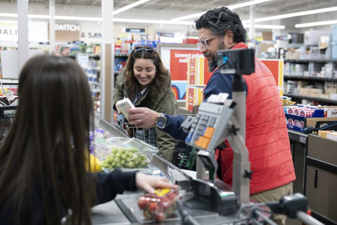 Negro-Henderson and her husband place their groceries on a conveyer belt in a checkout lane at Aldi.