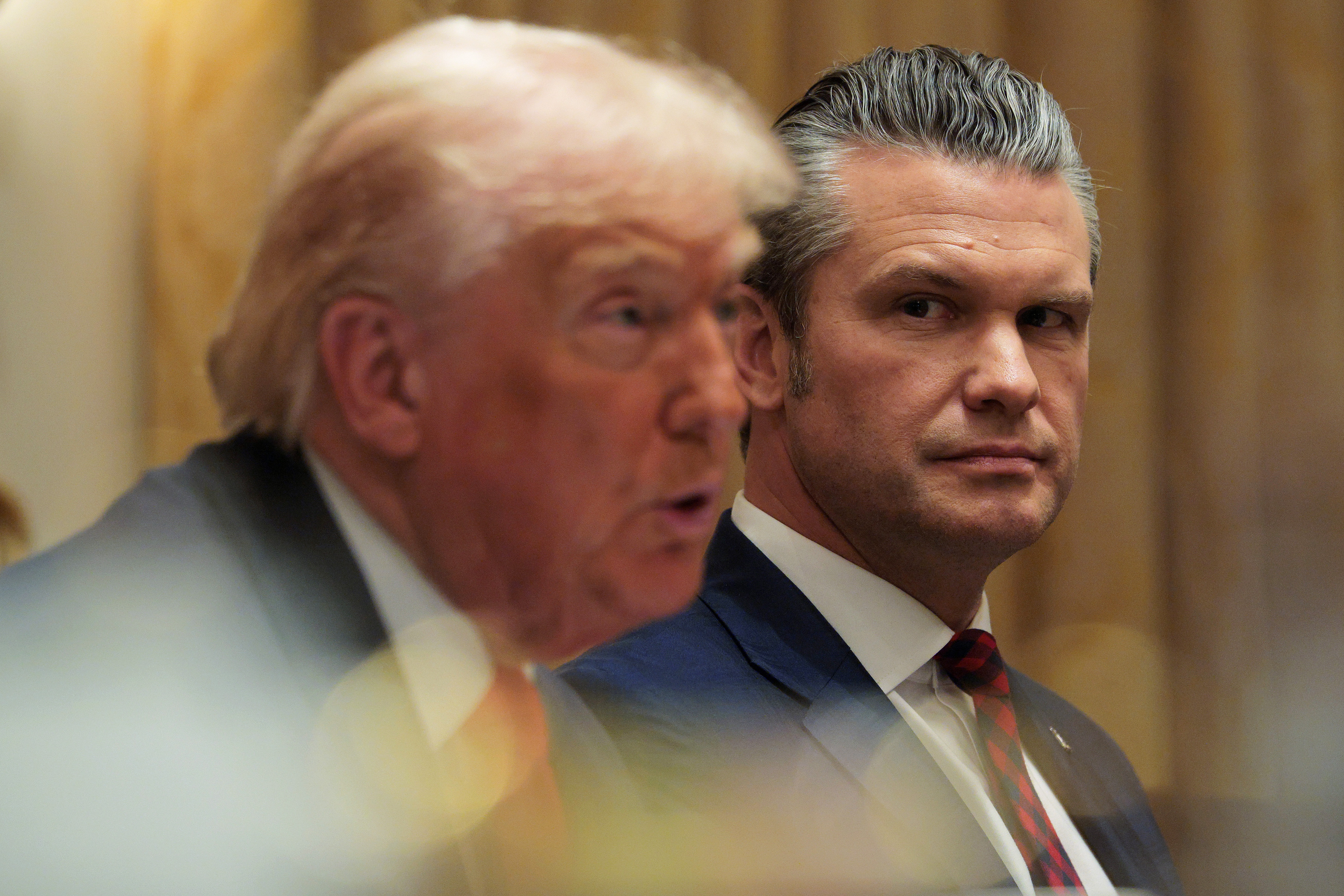 Secretary of Defense Pete Hegseth looks on as President Trump speaks during a Cabinet meeting at the White House on Wednesday.