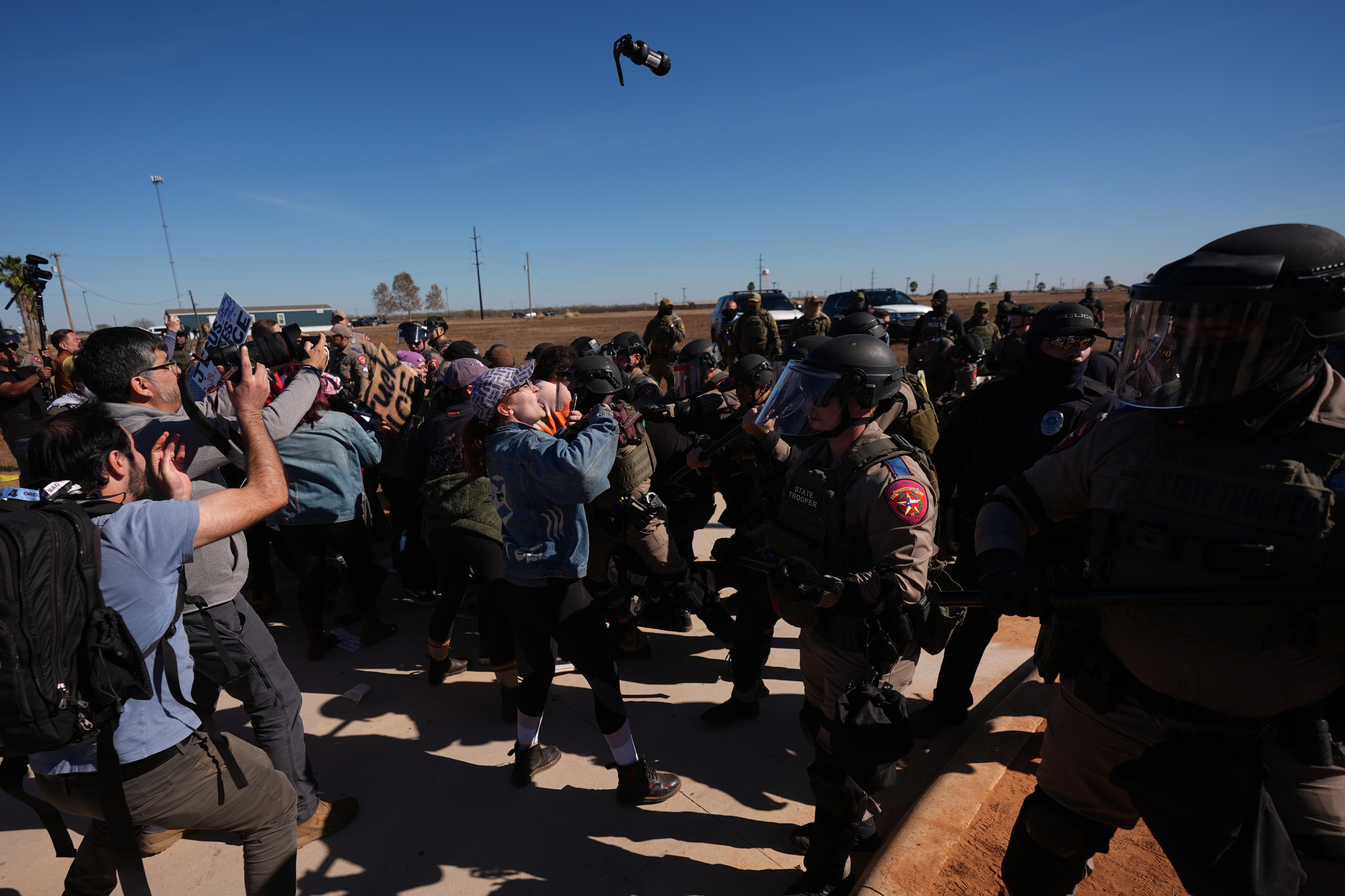 A canister of pepper spray launched by Texas troopers flies towards protesters outside the South Texas Family Residential Center detention facility where Liam Ramos and his father are being detained in Dilley, Texas, Wednesday, Jan. 28, 2026.