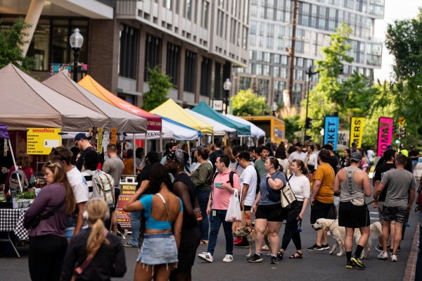 People walk around a farmer’s market in the NoMa neighborhood of D.C.