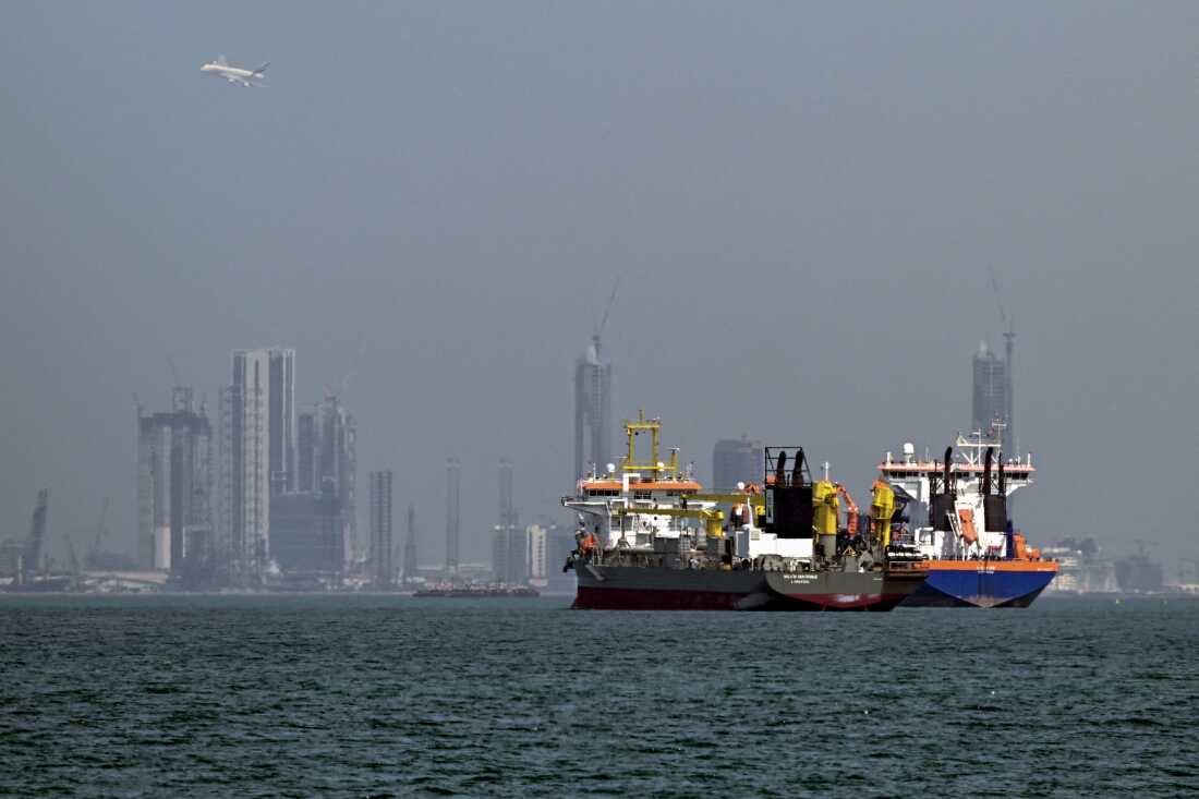Commercial vessels offshore in Dubai on March 11, 2026. Attacks hit three commercial ships in the Gulf on March 11 as Iran pressed its campaign against its oil-exporting neighbors, threatening shipping in the Strait of Hormuz. 