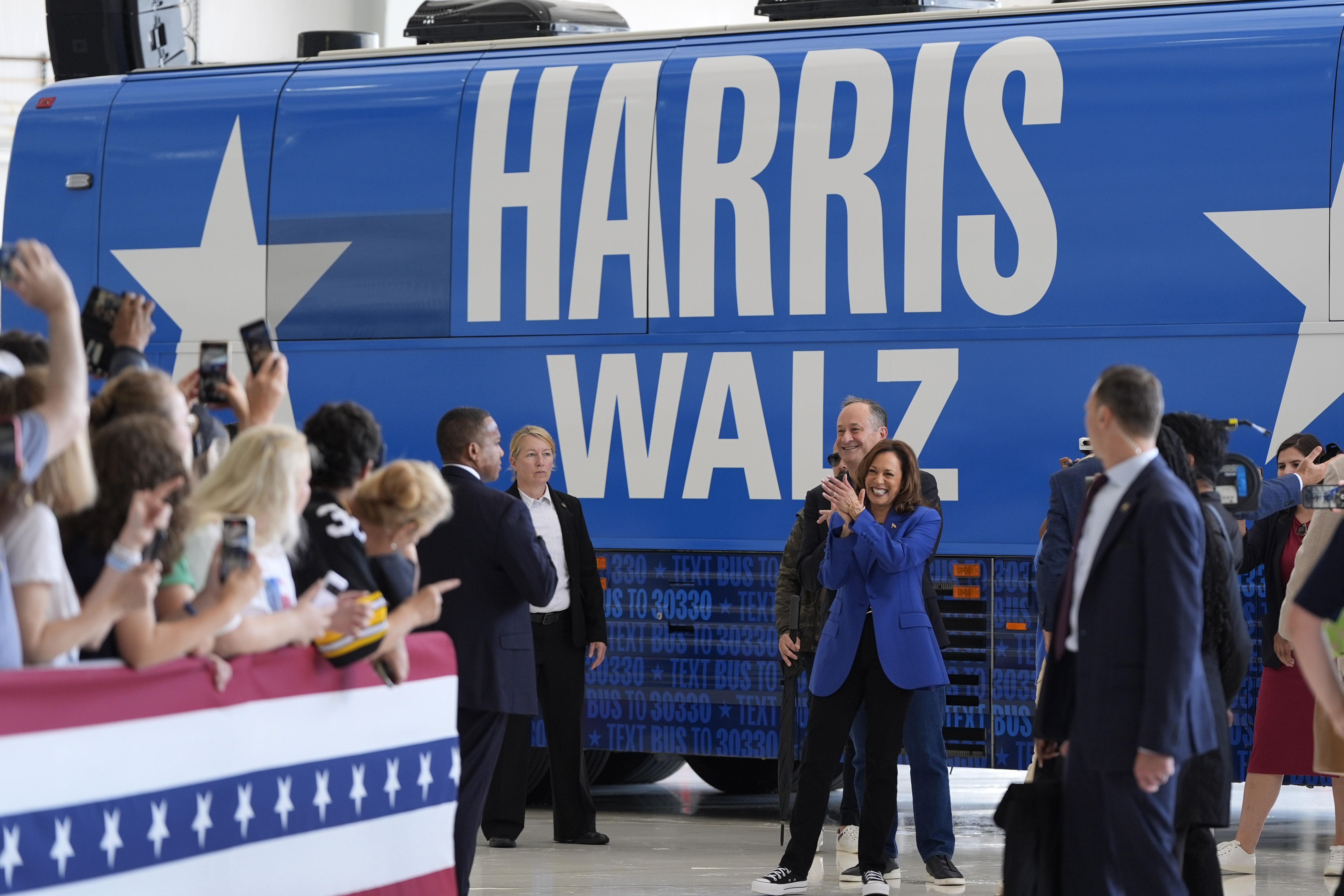 Democratic presidential nominee Vice President Kamala Harris and her husband, Doug Emhoff, greet supporters at Pittsburgh International Airport in Pittsburgh on Sunday. 