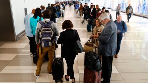 Passengers stand in the TSA pre-check line at LaGuardia Airport on Thursday in New York.