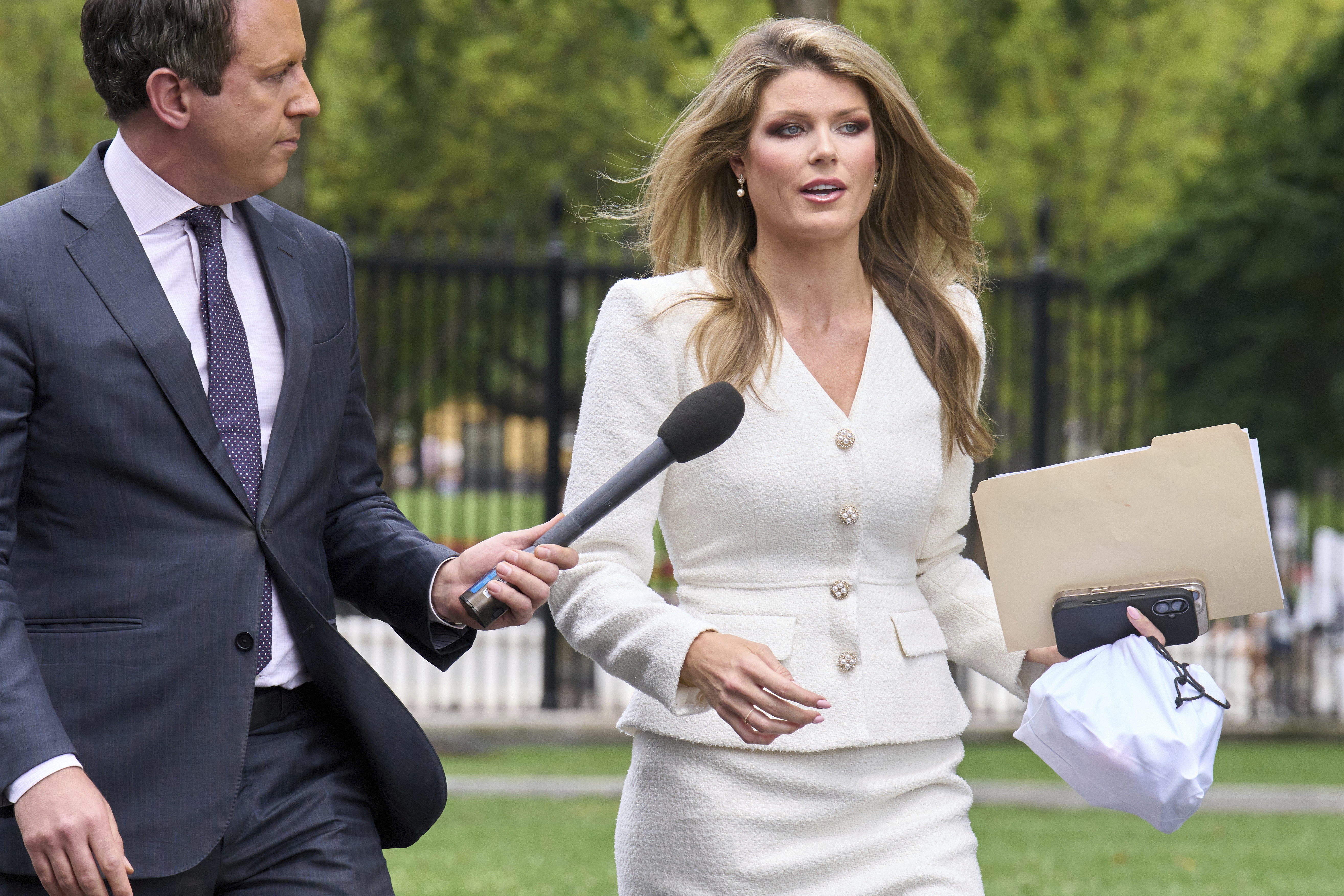 FILE - Lindsey Halligan, special assistant to the president, speaks with a reporter outside of the White House, Wednesday, Aug. 20, 2025, in Washington.