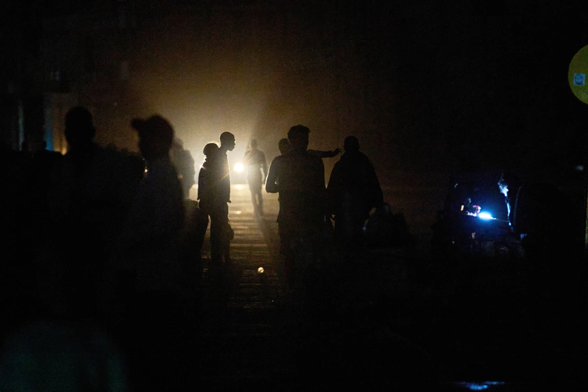 People walk on a street in the dark during a blackout in Havana, Cuba, Saturday, March 21, 2026.