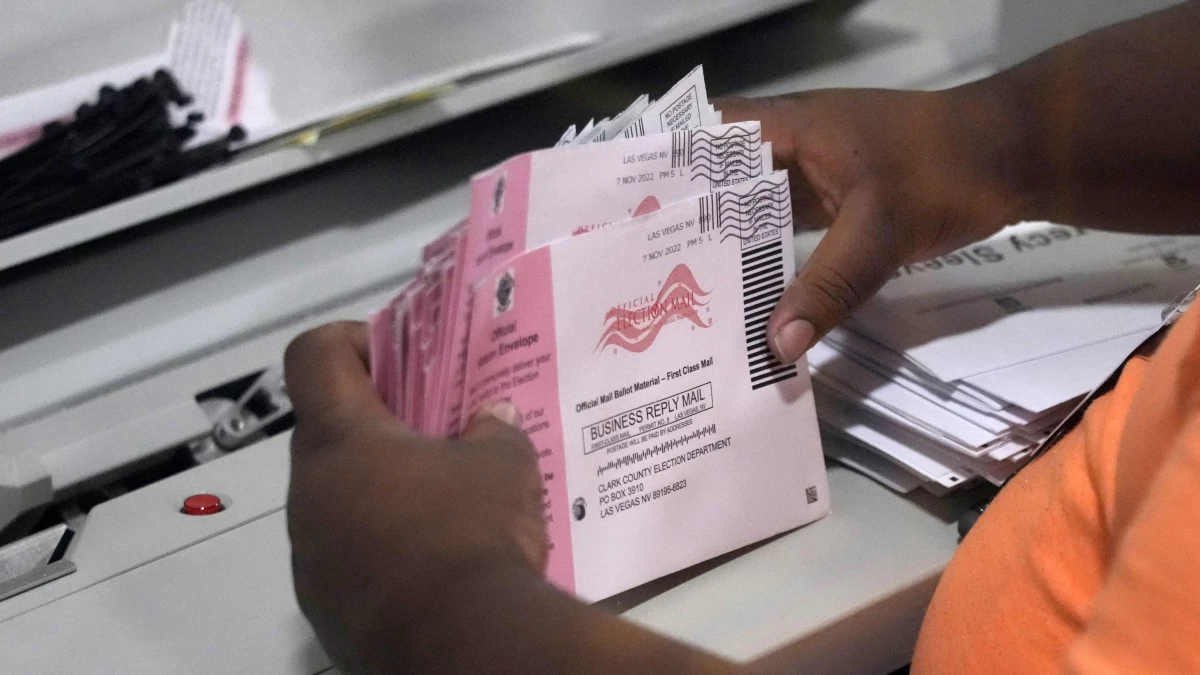 An election worker prepares mail ballots at the Clark County Election Department on Nov. 8, 2022, in Las Vegas. The Republican National Committee and the Trump campaign have filed a federal lawsuit seeking to prevent Nevada from counting mail ballots received after Election Day, as state law permits.