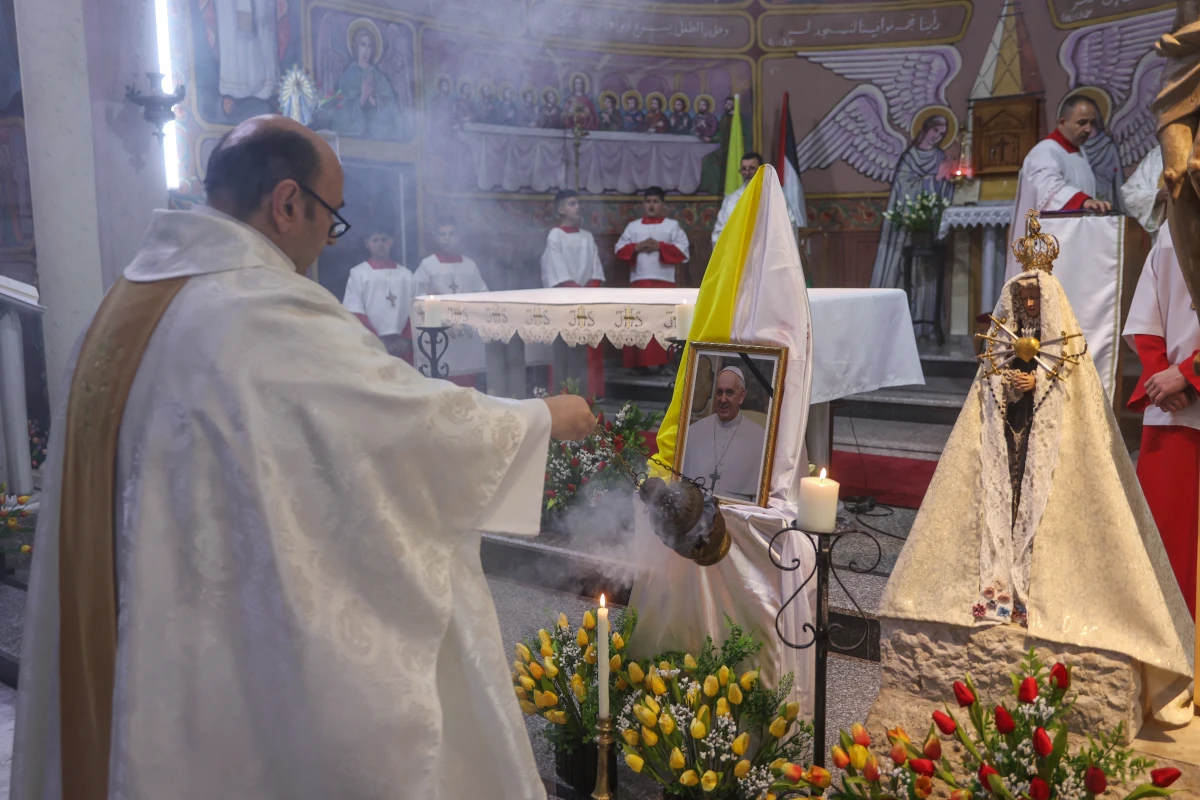 Members of the clergy hold Mass for late Pope Francis at the Holy Family Church in Gaza City on Monday. Palestinian Christians in Gaza mourned the death of Pope Francis, who had maintained close and consistent contact with the besieged territory's small Christian community throughout the ongoing war with Israel.