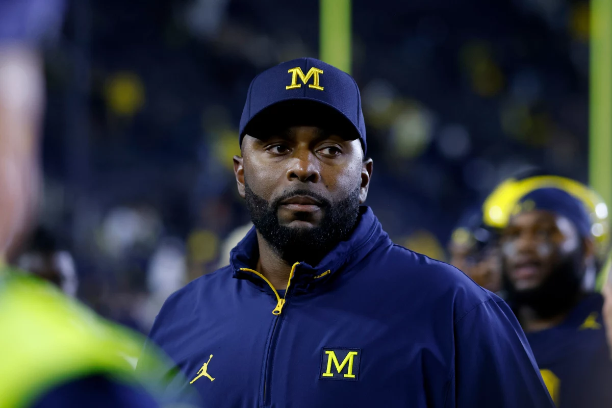 Then-Michigan football coach Sherrone Moore walks off the field following a game Aug. 30, 2025, in Ann Arbor, Mich. Moore has been charged with three crimes, including felony home invasion and stalking, after prosecutors said he 'barged his way' into the apartment of a woman with whom he had been having an affair.