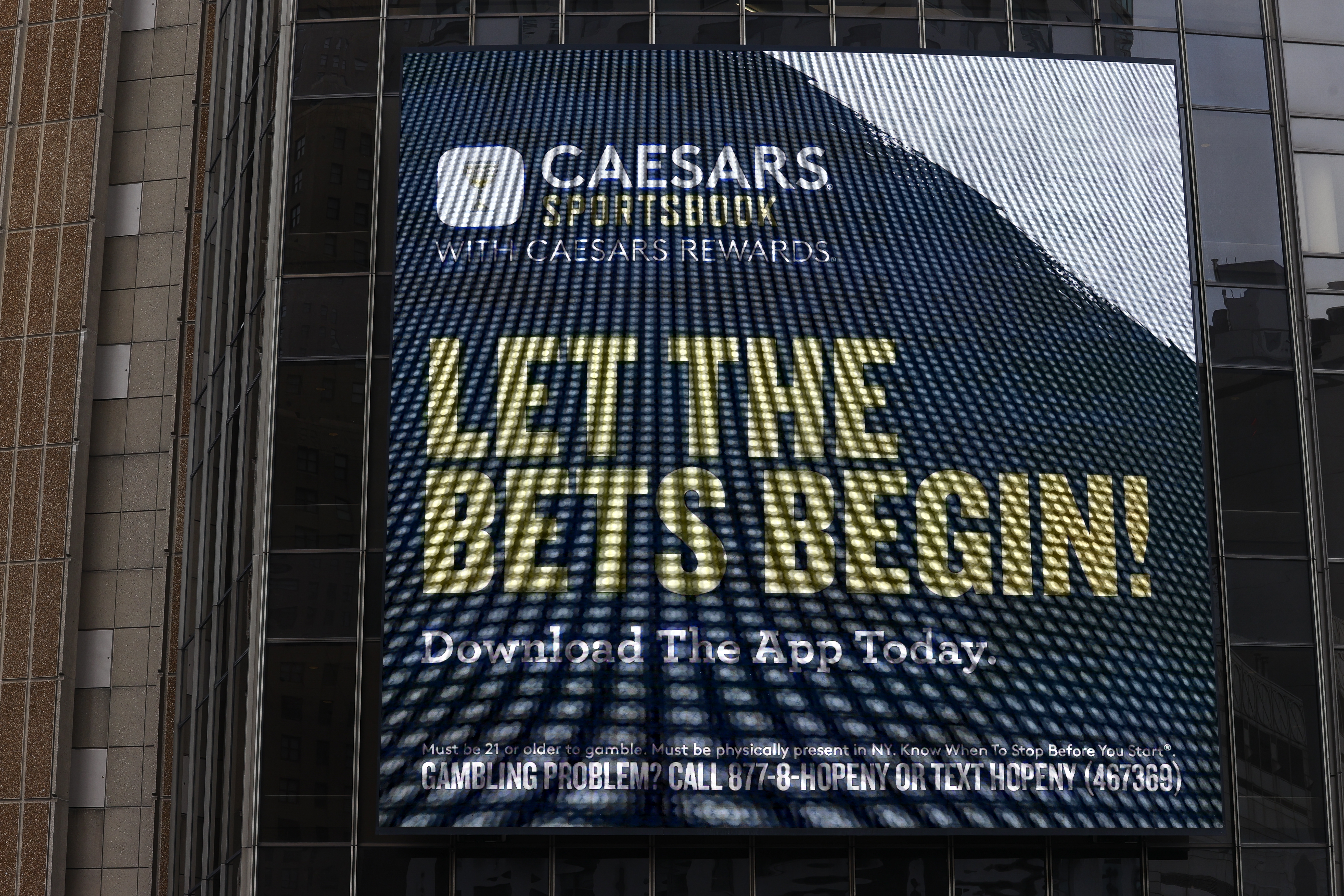 A Caesars Sportsbook gambling advertisement on the exterior of a building in New York City in 2024.