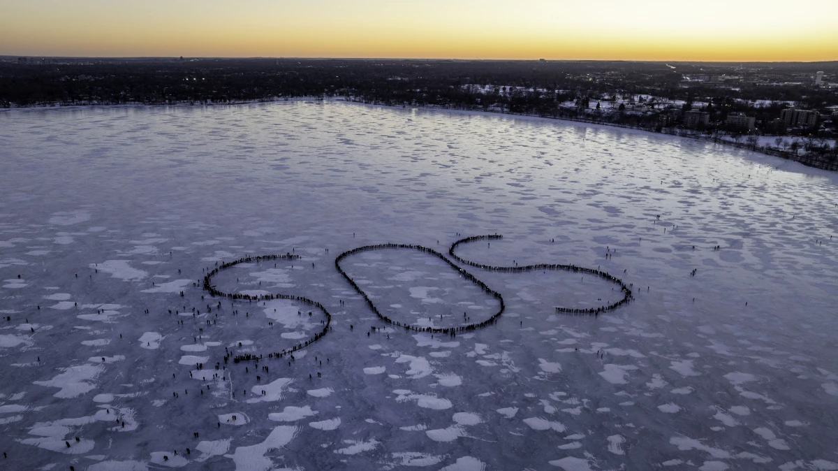 Demonstrators spell out an SOS signal of distress on a frozen lake in Minneapolis, in the aftermath of the shooting deaths of Renee Macklin Good and Alex Pretti by federal immigration agents.