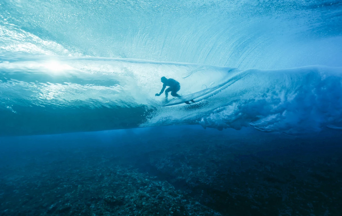 France's Joan Duru rides in a barrel in Teahupo'o, skimming feet above the ocean floor.