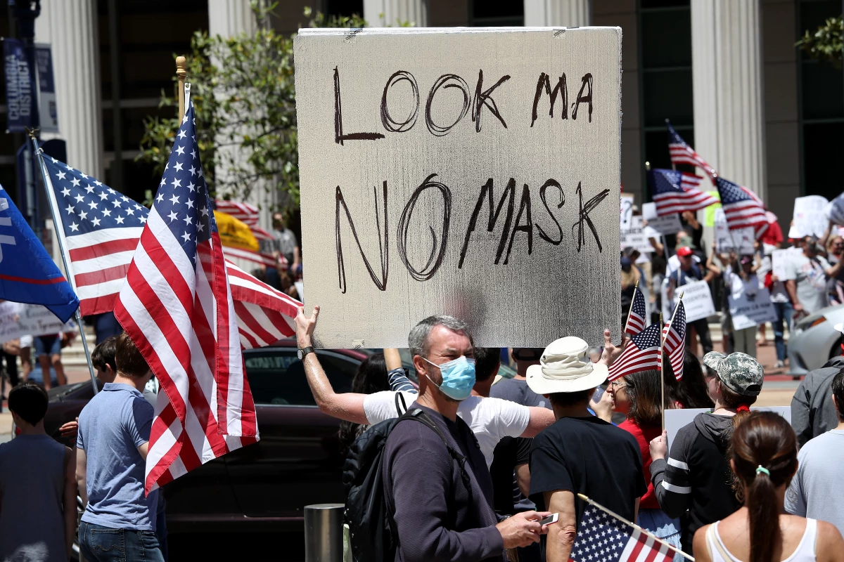 May 1, 2020: Activists hold signs and protest the California lockdown due to the COVID-19 pandemic in San Diego.