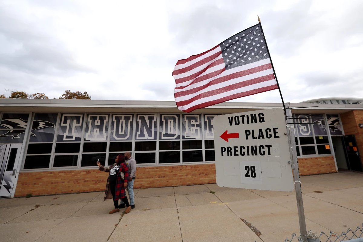 Voters take a selfie after casting ballots at Edsel Ford High School on Nov. 5 in Dearborn, Mich.