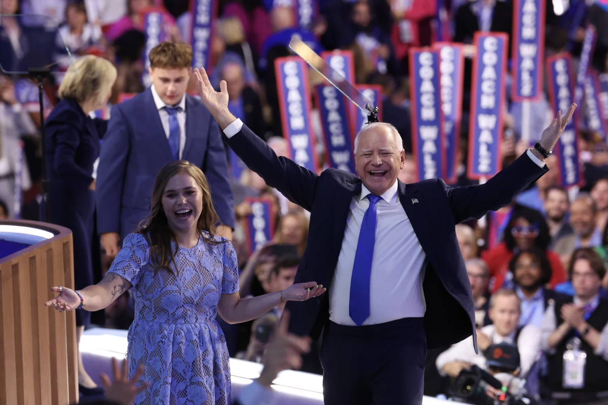 Democratic vice presidential nominee Minnesota Gov. Tim Walz reacts with his daughter Hope Walz after accepting the Democratic vice presidential nomination on stage during the third day of the Democratic National Convention.