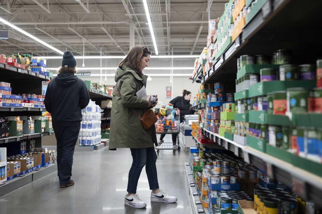 Rachel Negro-Henderson stands in an aisle, looking at shelves of canned food, at the Aldi in Bellmawr, New Jersey, on March 2.