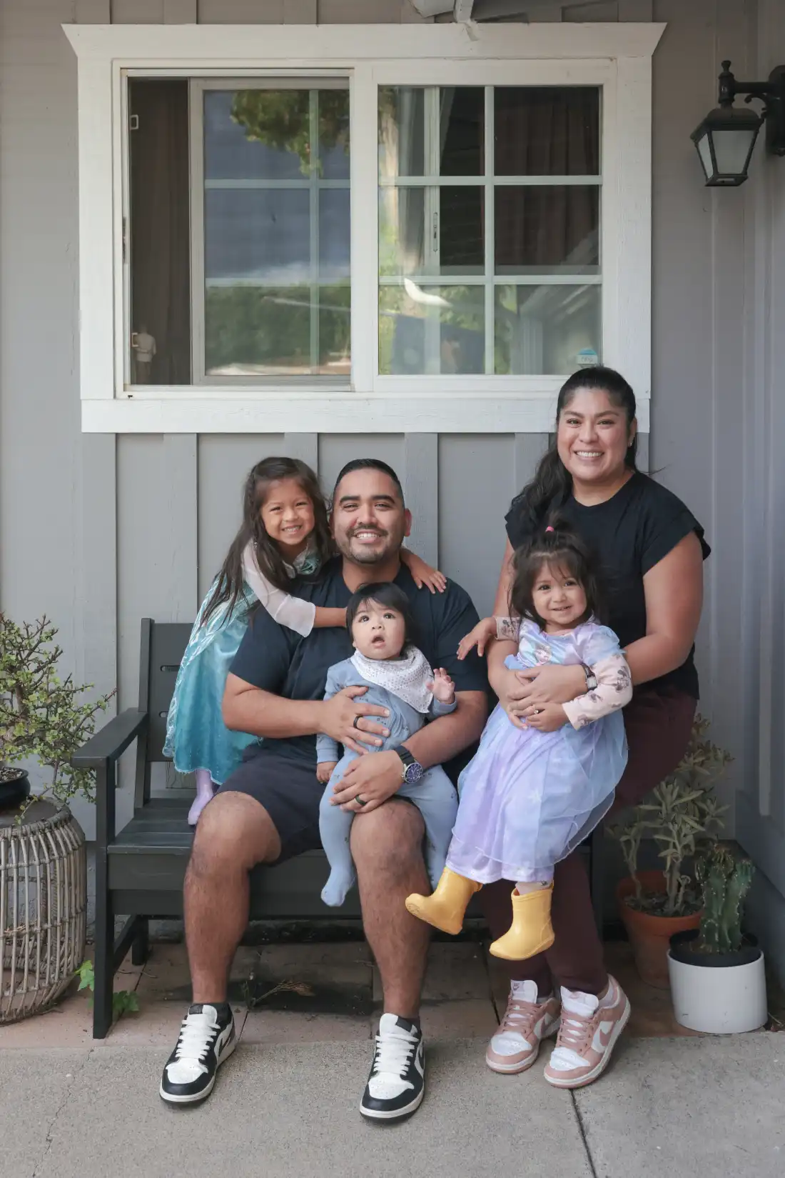 Karlo Campana poses for a portrait with his wife Lily and their three kids (from left to right) Gianna, Gianluca, and Giselle.