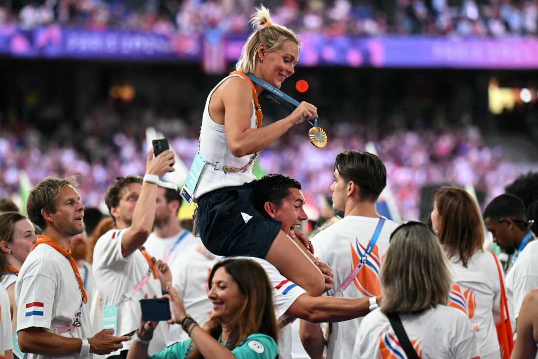 Gold medallist of women's marathon swimming Netherland's Sharon Van Rouwendaal celebrate with her medal on Sunday.