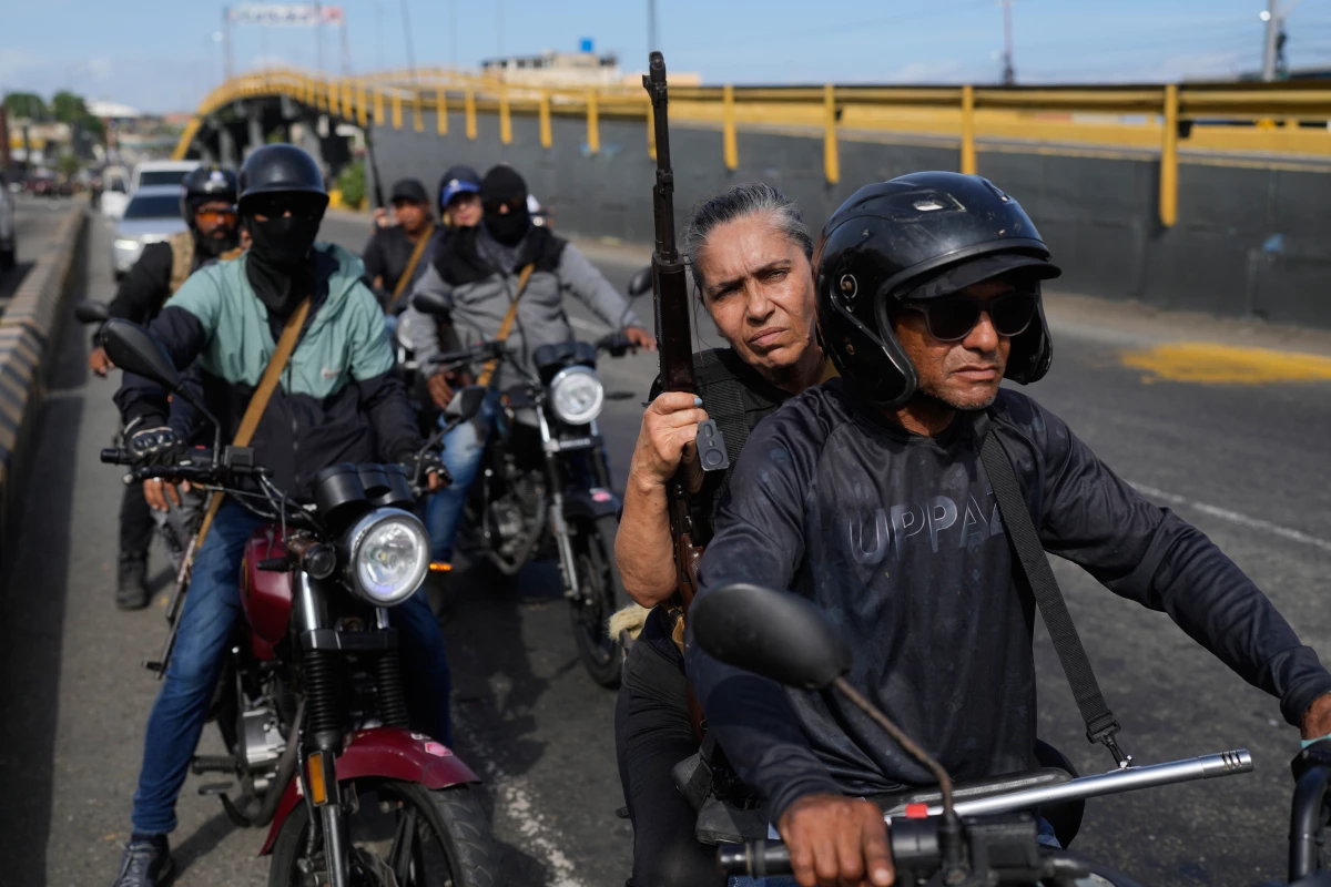 Pro-government armed civilians patrol in La Guaira, Venezuela after President Trump announced that President Nicolás Maduro had been captured and flown out of the country.