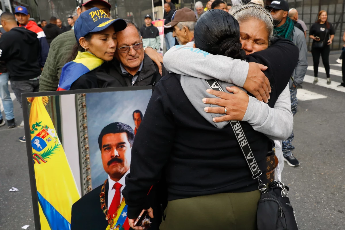 Supporters of Venezuelan President Nicolás Maduro embrace in downtown Caracas, Venezuela.