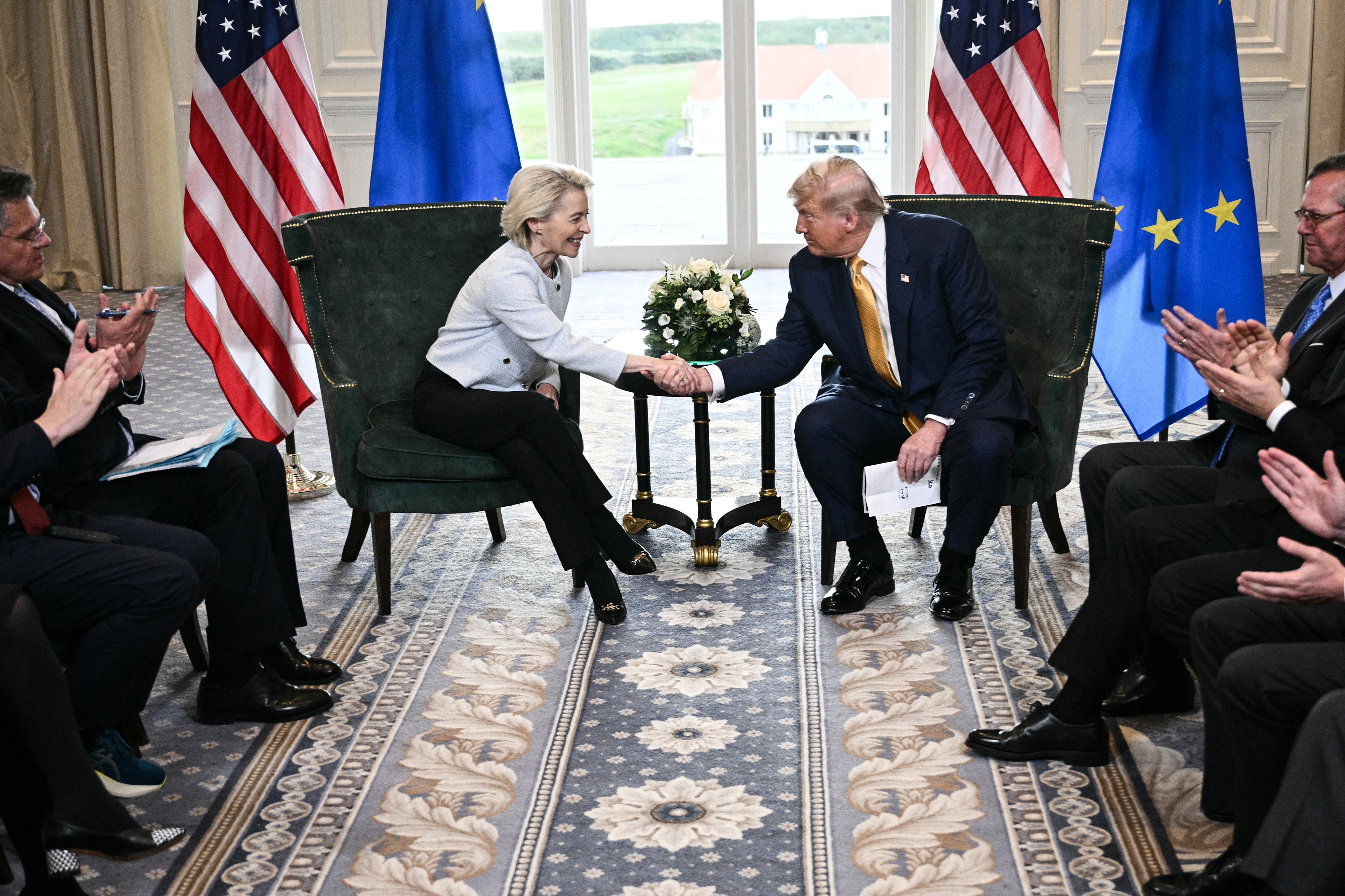 President Trump shakes hands with European Commission President Ursula von der Leyen on Sunday at his golf resort in Turnberry, Scotland, after the two leaders agreed to terms for a trade deal. (AFP via Getty Images)