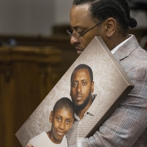 Antonio Mays Sr. holds a picture of himself and his son, Antonio Mays Jr., in Superior Court at the King County Courthouse in Seattle on Dec. 10, 2025.