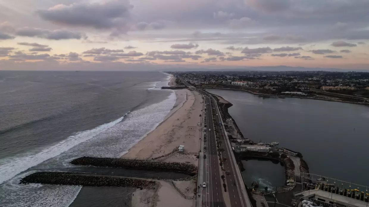 A drone view shows the Carlsbad desalination plant's intake lagoon on the right and the discharge canal on the left, Tuesday, Dec. 2, 2025, in Carlsbad, Calif.